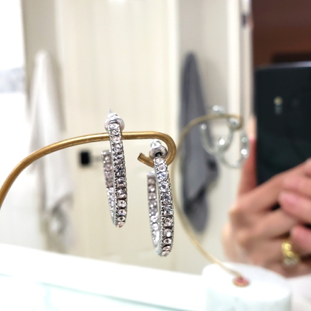 Beautiful Zoconia hoop hugging earrings in silvertone.